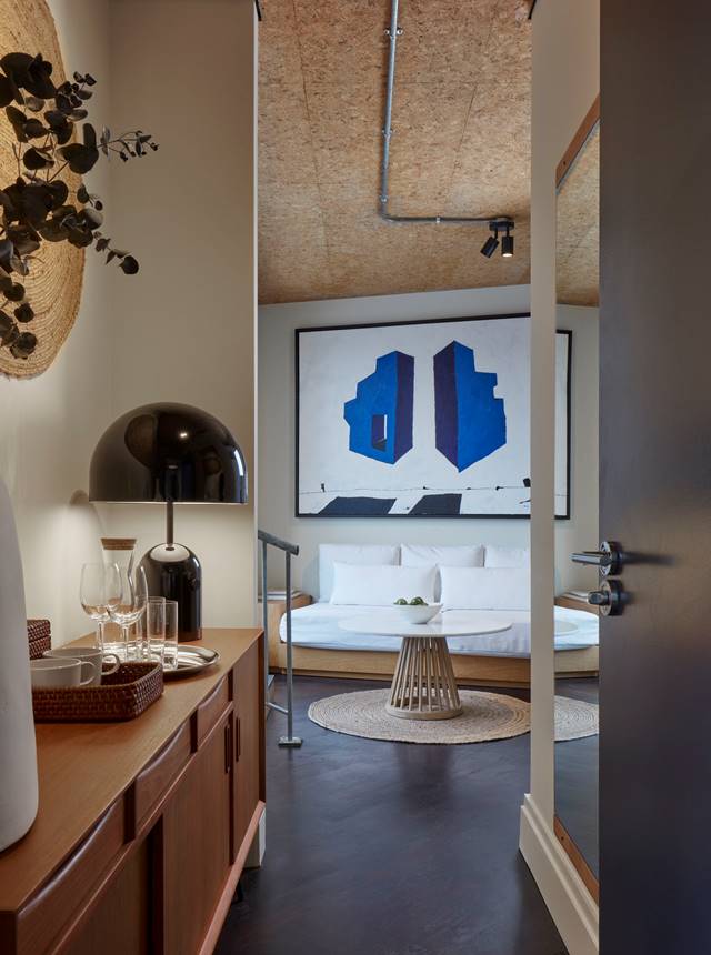 A modern and stylish bedroom featuring a comfortable bed, chic decor, and ambient lighting for a cosy atmosphere.