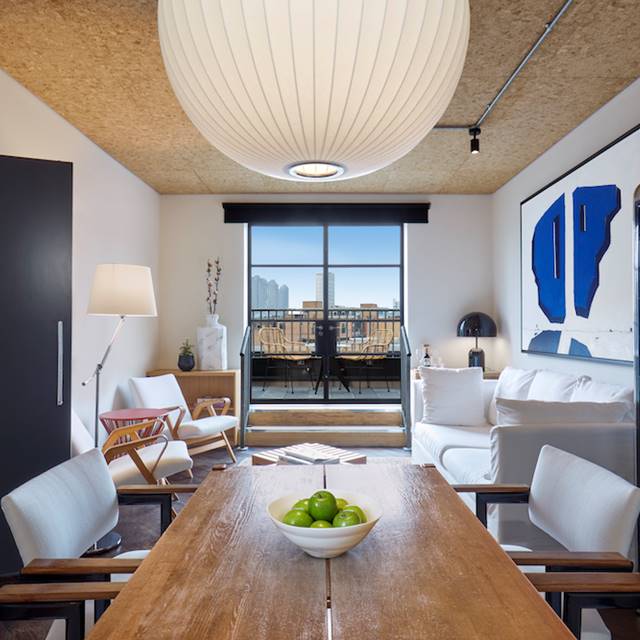 A contemporary apartment featuring a stylish dining table surrounded by elegant chairs, showcasing modern interior design.