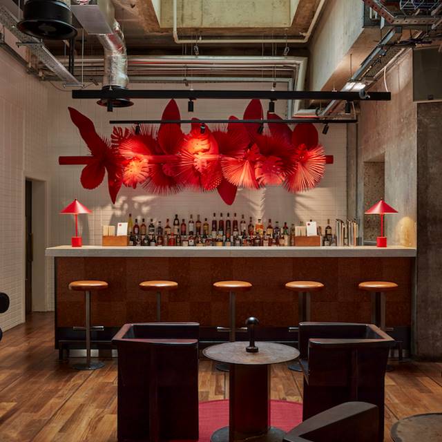 The stylish lobby bar, showcasing a sleek design with plush seating, elegant bar stools, and a well-stocked bar. 